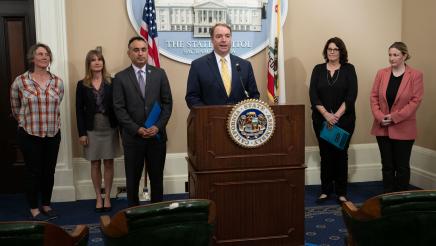 Asm. Connolly at podium, speaking